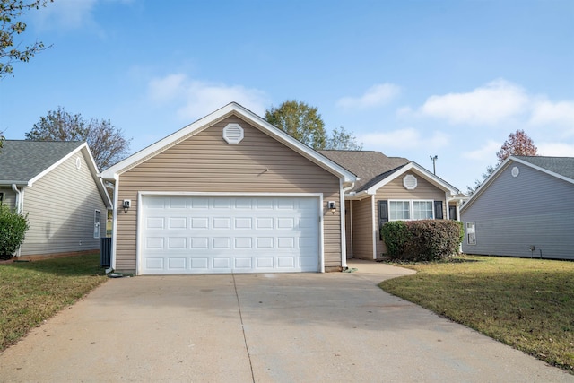 view of front of property with a garage and a front lawn