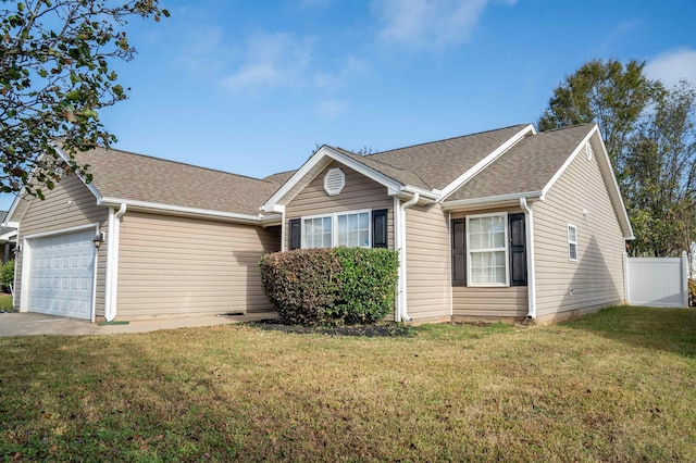 single story home with a garage and a front lawn