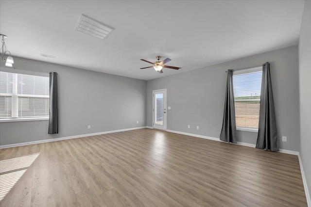 empty room with light hardwood / wood-style flooring and ceiling fan