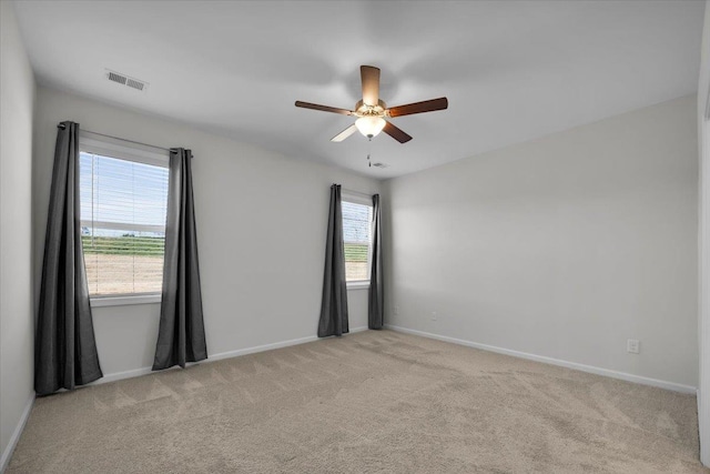 carpeted empty room featuring ceiling fan