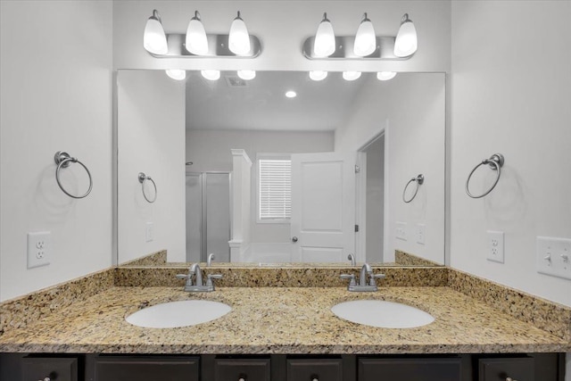 bathroom with vanity and a shower with door