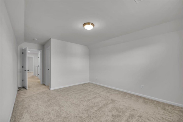 bonus room featuring light carpet