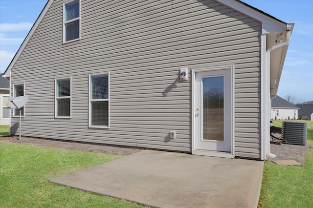 back of property featuring a yard, central AC, and a patio