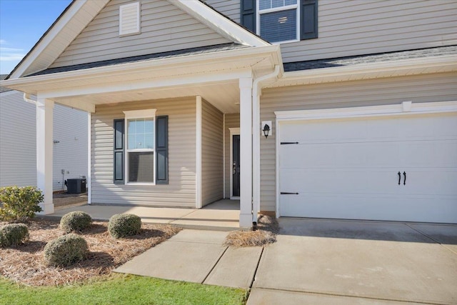 view of exterior entry with a porch, a garage, and central air condition unit