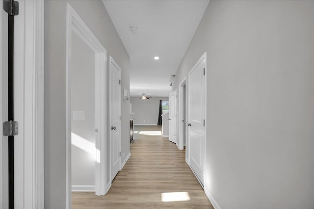 hallway with light hardwood / wood-style flooring