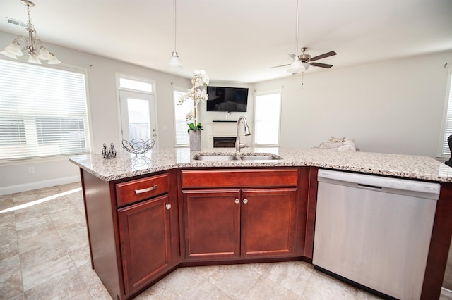 kitchen featuring light stone counters, stainless steel dishwasher, a kitchen island with sink, and sink