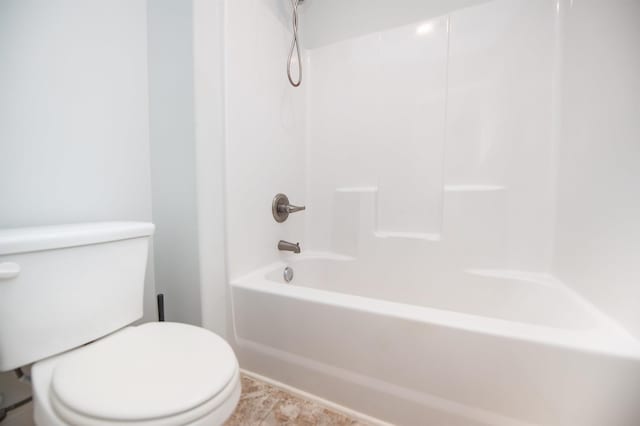 bathroom featuring toilet and bathing tub / shower combination