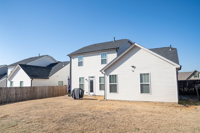 back of house with a yard