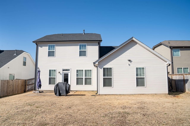 back of house with a lawn