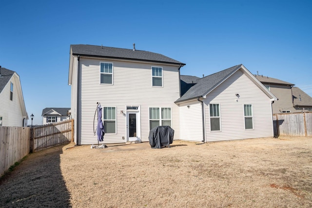 rear view of property with a yard