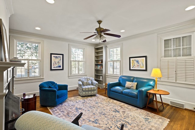 living room with crown molding, dark hardwood / wood-style floors, and ceiling fan