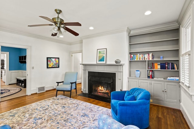 living room featuring crown molding, dark hardwood / wood-style floors, and ceiling fan