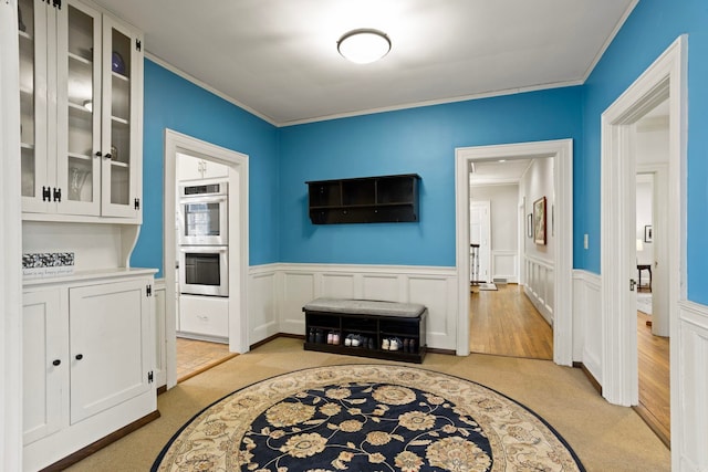 interior space with ornamental molding and light carpet