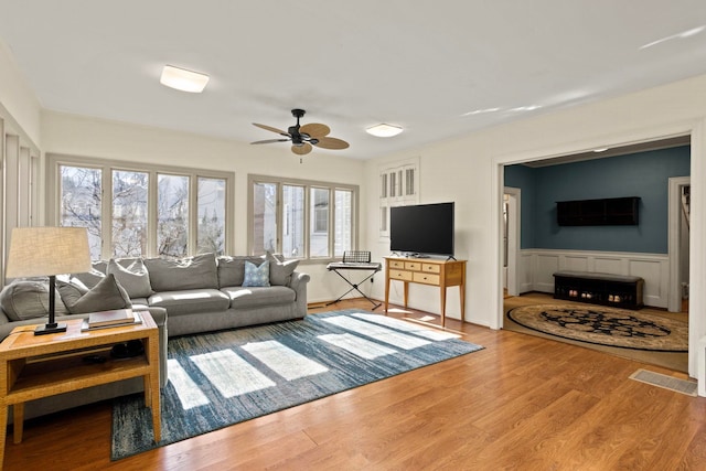 living room with ceiling fan and hardwood / wood-style floors