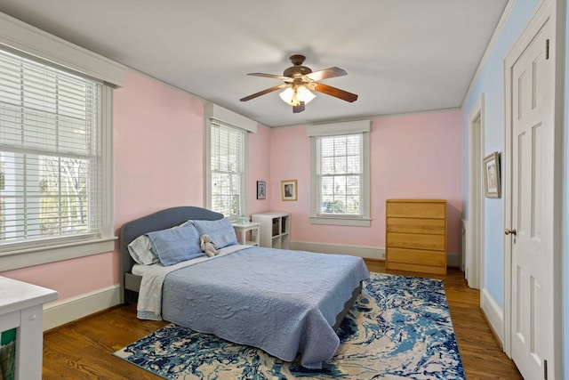 bedroom with ceiling fan and hardwood / wood-style floors