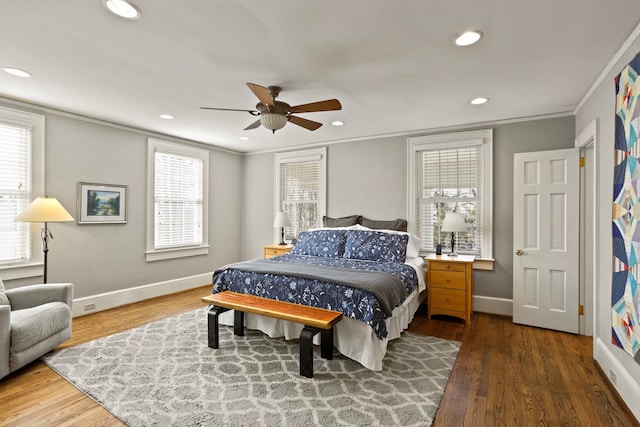 bedroom with hardwood / wood-style floors, crown molding, and ceiling fan