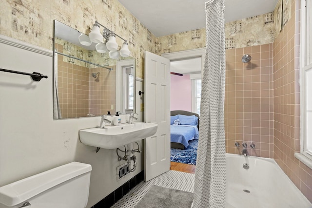 full bathroom featuring sink, toilet, and shower / bath combo with shower curtain