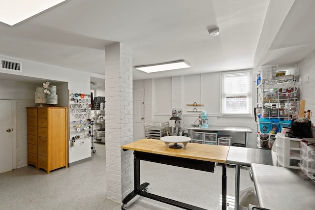 interior space featuring decorative columns and white cabinets