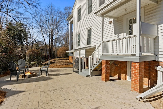 view of patio with a grill and an outdoor fire pit