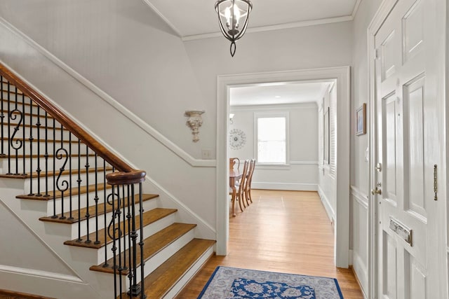 entrance foyer featuring crown molding and hardwood / wood-style floors