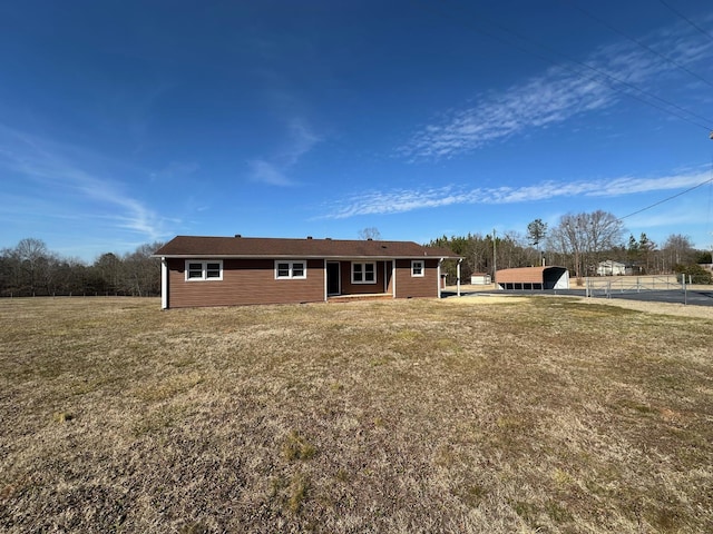 rear view of property with a yard