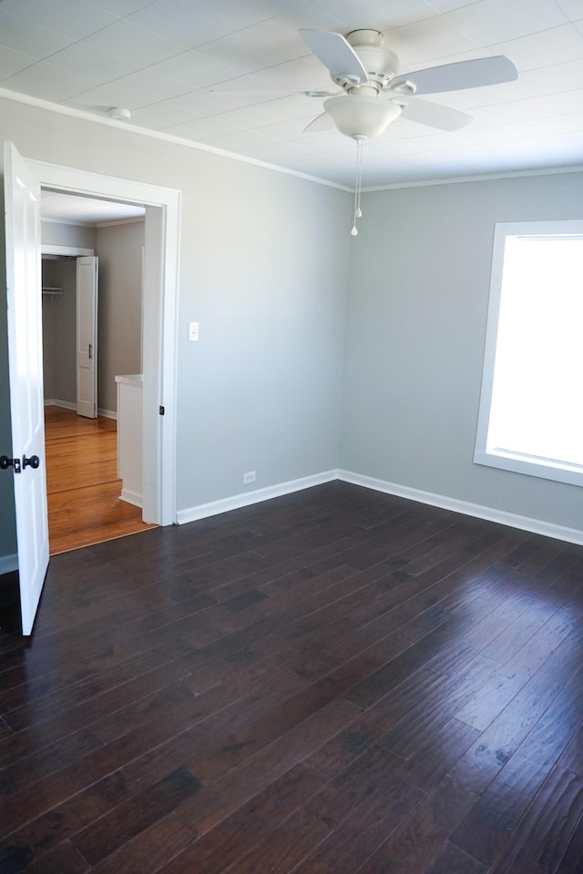 spare room featuring ornamental molding, dark hardwood / wood-style floors, and ceiling fan