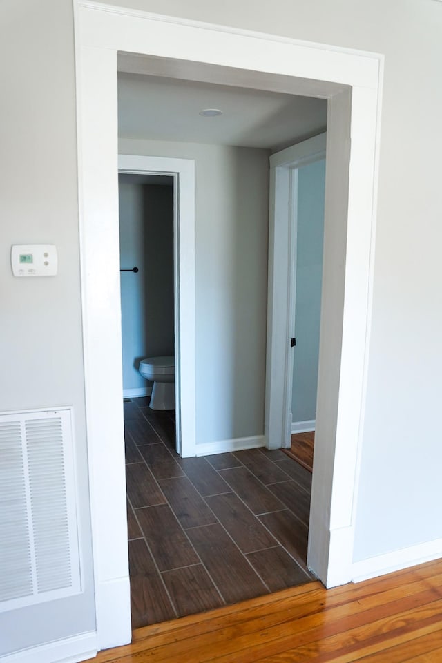 hall with dark hardwood / wood-style flooring