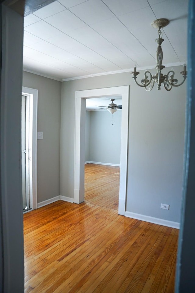 unfurnished dining area with crown molding and wood-type flooring