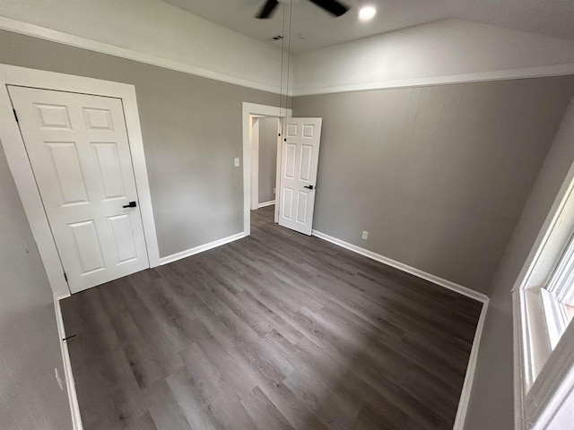 unfurnished bedroom with dark wood-type flooring, ceiling fan, and vaulted ceiling