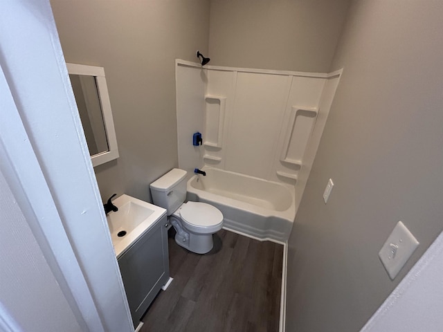 full bathroom with hardwood / wood-style flooring,  shower combination, toilet, and vanity