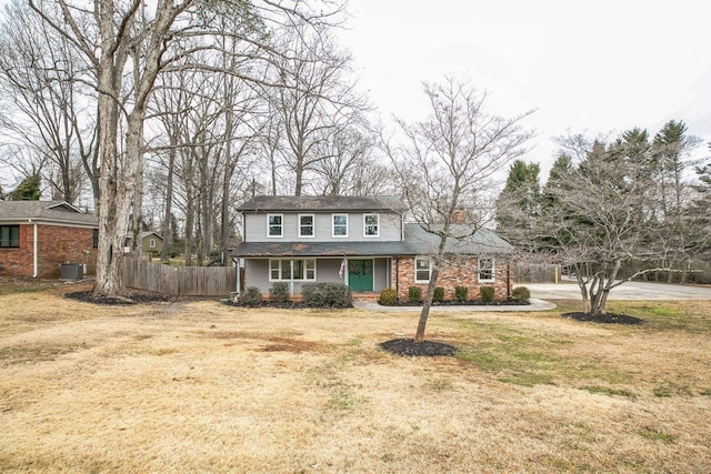 view of front of house featuring central AC and a front yard