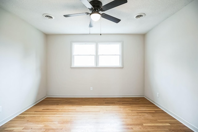 unfurnished room with ceiling fan, light hardwood / wood-style flooring, and a textured ceiling