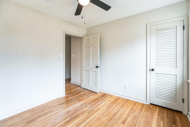 unfurnished bedroom featuring light hardwood / wood-style floors, a closet, and ceiling fan