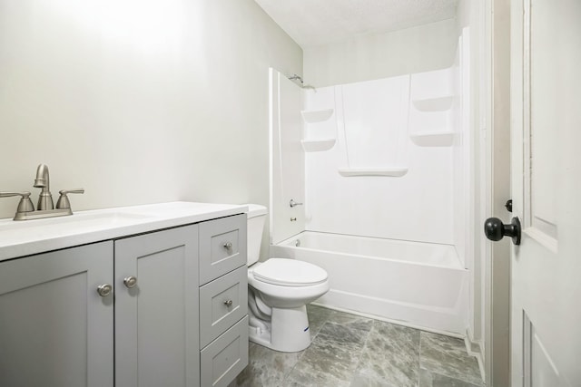 full bathroom with vanity, a textured ceiling, washtub / shower combination, and toilet