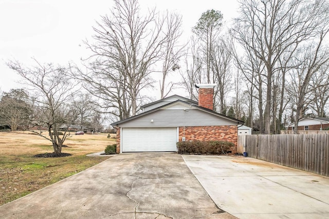 view of home's exterior featuring a garage and a yard