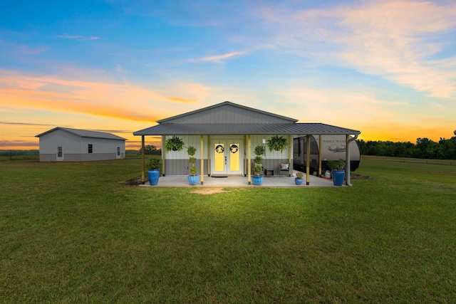 back house at dusk with a yard