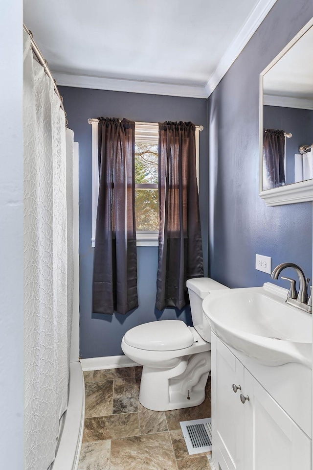 bathroom featuring ornamental molding, toilet, and vanity