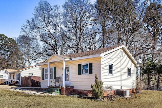 view of front facade with central AC and a front lawn