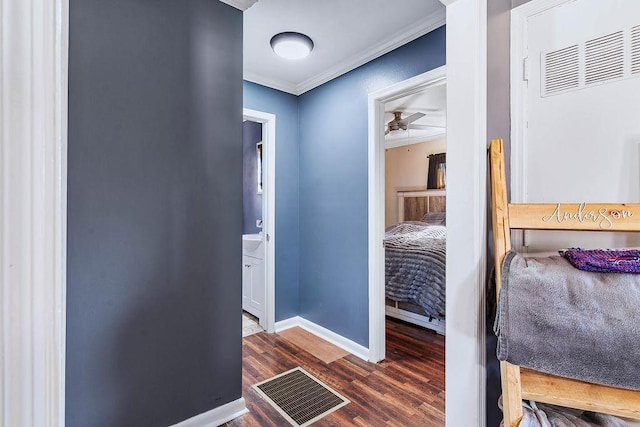 hallway featuring dark hardwood / wood-style flooring and ornamental molding