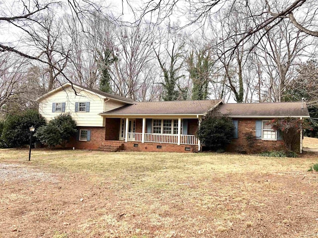 tri-level home featuring a front yard and a porch