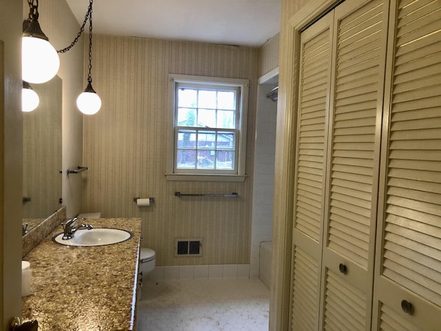 bathroom with vanity and toilet