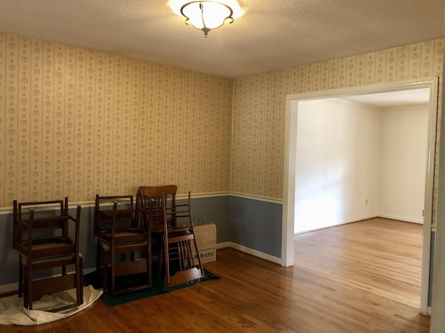 dining room featuring hardwood / wood-style floors and a textured ceiling