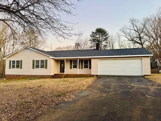 single story home featuring aphalt driveway, an attached garage, a shingled roof, crawl space, and a chimney