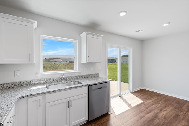 kitchen with sink, dishwasher, white cabinetry, dark hardwood / wood-style floors, and light stone counters