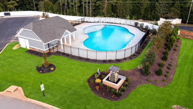 view of swimming pool featuring a patio and a lawn