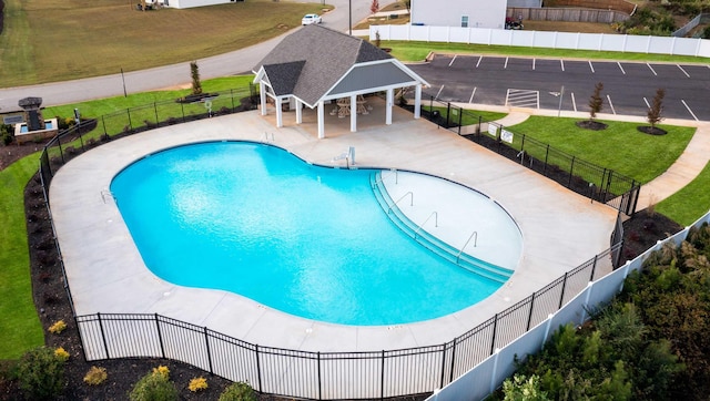 view of pool featuring a gazebo, a lawn, and a patio