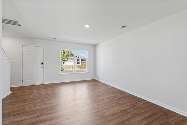 empty room with dark hardwood / wood-style flooring