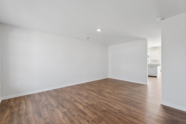 unfurnished room with dark wood-type flooring