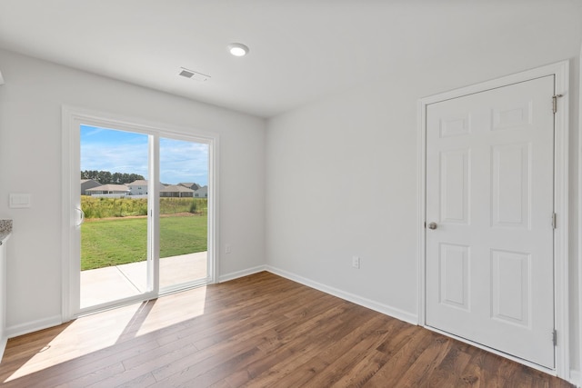 unfurnished room with dark wood-type flooring