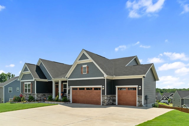 craftsman inspired home featuring a garage and a front yard